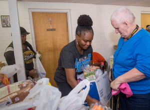 Faith Health, food bank at Mount Moriah Outreach Center, Bishop Todd Fulton w wife & first lady Theresa Fulton distribute food boxes. Tonya Ingram- panther's t-shirt Manager Food Bank, Care coordinator WFBMC, Minister Claude Mitchell-WF jacket,grey hat, Deacon James Miller-tall w dreads,Chaplain Angela Chavis-Faith Health advisor, Sherry Switzer-Pittsburgh Steelers t shirt, Minister Marlene McKinnon -WF jersey,Nadine Griffin-white woman w Bishop Fulton,Frederick Ford-wearing A's cap,Lee M. Patrick-yellow raincoat.